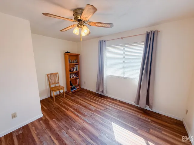 a view of room with window and ceiling fan