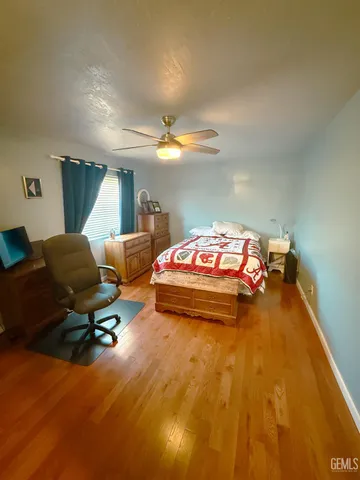 a bedroom with bed and window