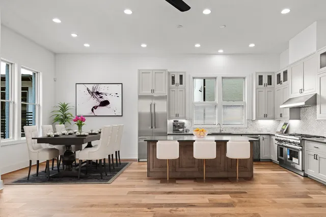 a kitchen with a sink cabinets and wooden floor