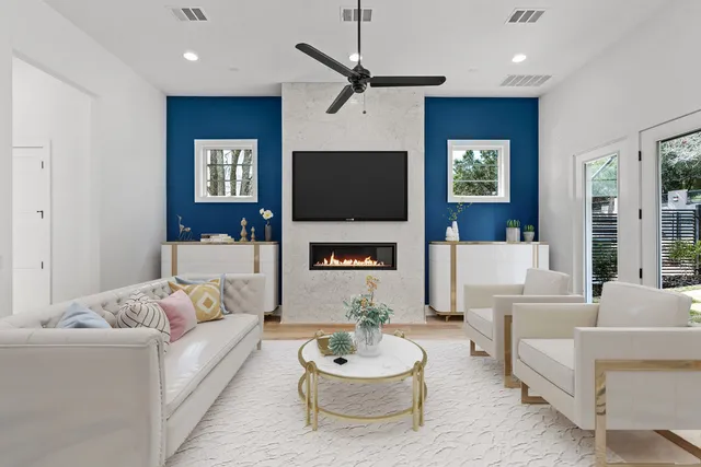 a living room with furniture a fireplace and a flat screen tv