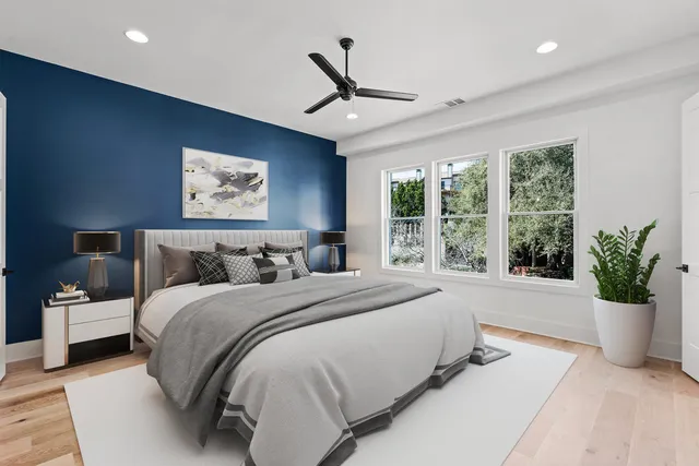 a spacious bedroom with a large bed and a large window