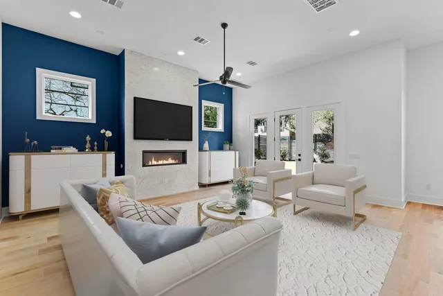 a living room with furniture a dining table and a flat screen tv