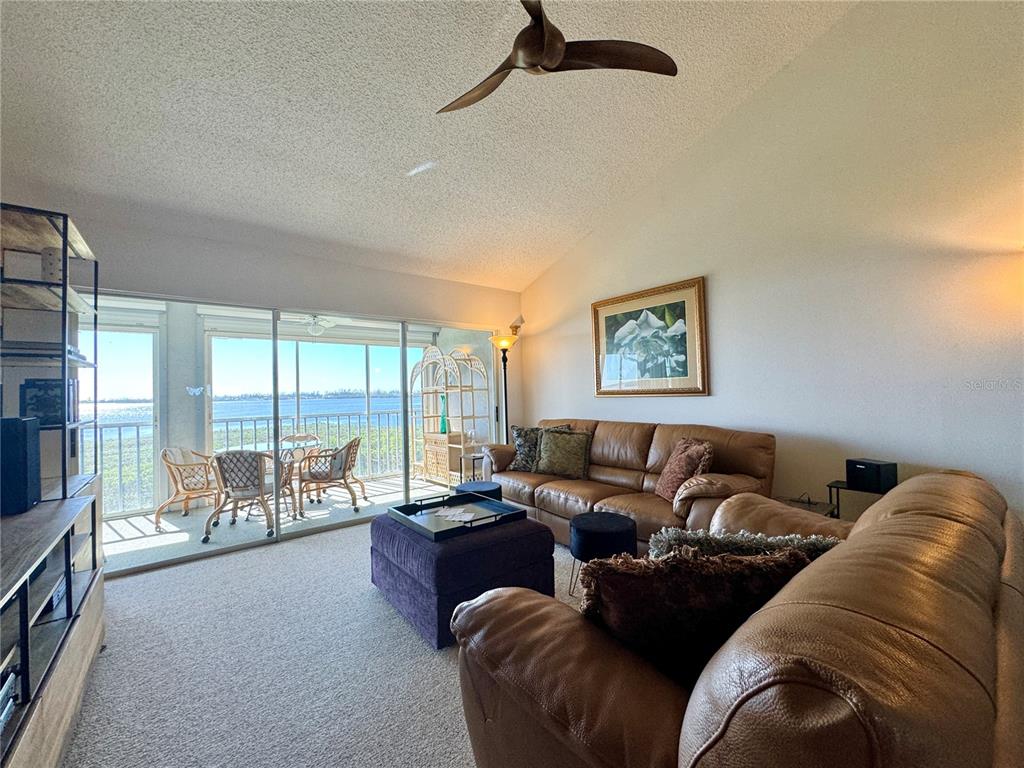 1155 Edgewater Circle, Unit 28 Bradenton, FL 34209 - Photo 11 of 50 a living room with furniture and a large window