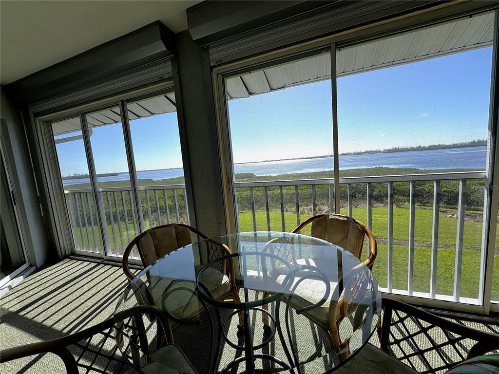 1155 Edgewater Circle, Unit 28 Bradenton, FL 34209 - Photo 19 of 50 a view of a porch with furniture and wooden floor