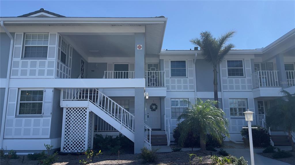 1155 Edgewater Circle, Unit 28 Bradenton, FL 34209 - Photo 2 of 50 a view of a house with a small yard and wooden floor and fence