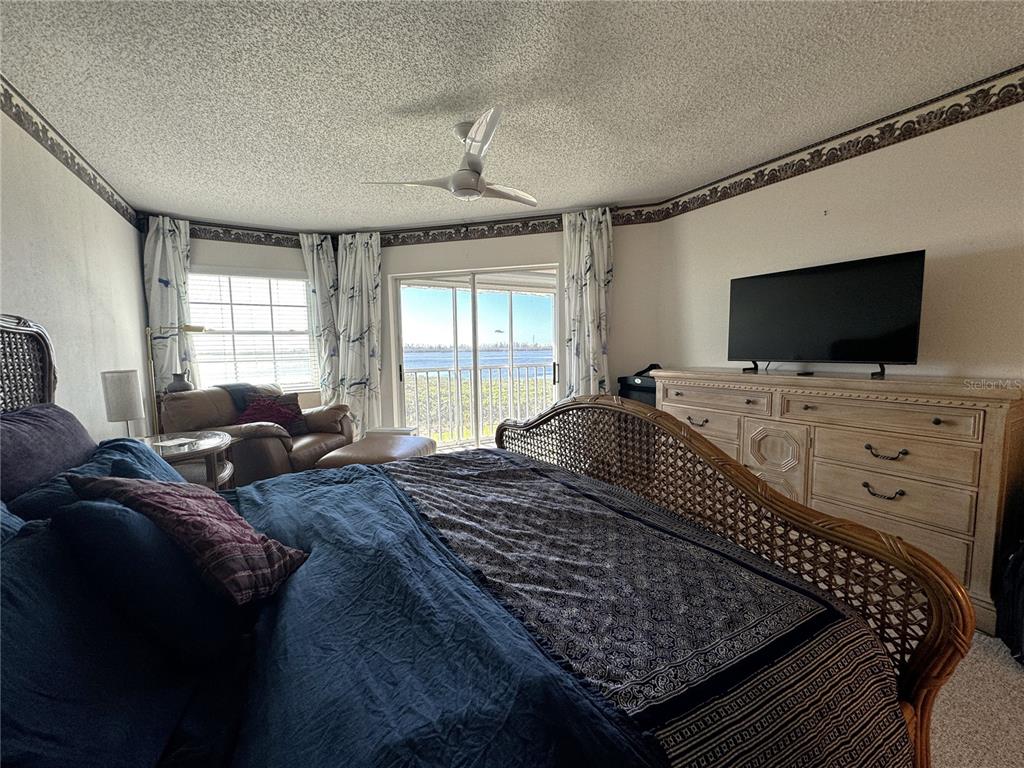 1155 Edgewater Circle, Unit 28 Bradenton, FL 34209 - Photo 25 of 50 a bed room with a bed and a television