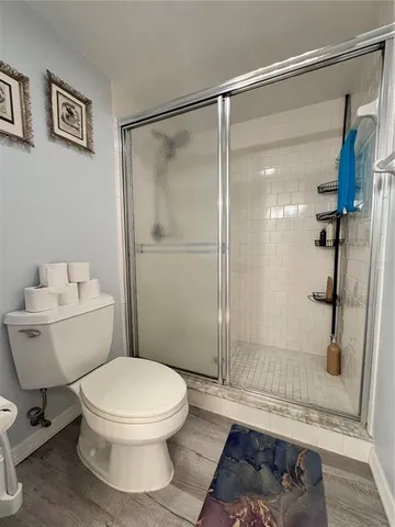 a bathroom with a toilet and a shower