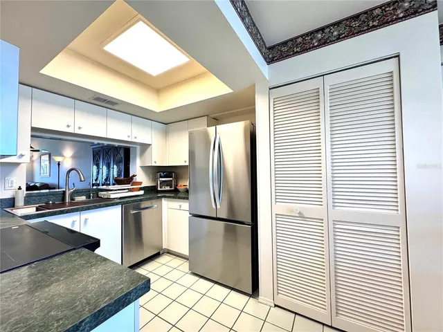 a kitchen with stainless steel appliances granite countertop a refrigerator and a sink