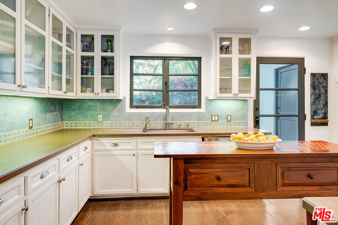 11670 Duque Drive Studio City, CA 91604 - Photo 13 of 48 a kitchen with granite countertop white cabinets and sink