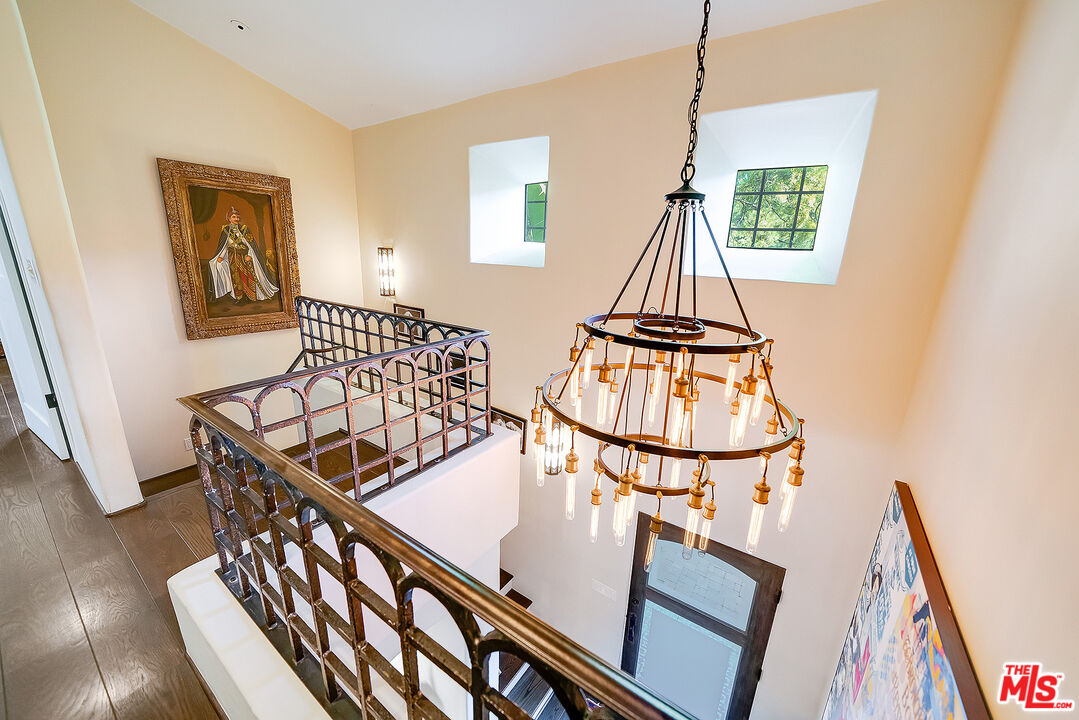 11670 Duque Drive Studio City, CA 91604 - Photo 15 of 48 a view of staircase with wooden floor and chandelier