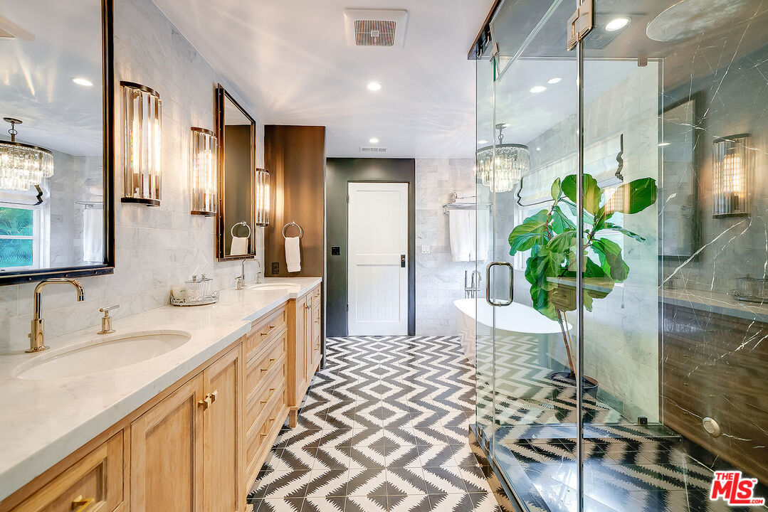 11670 Duque Drive Studio City, CA 91604 - Photo 19 of 48 a bathroom with a double vanity sink a potted plant and a shower