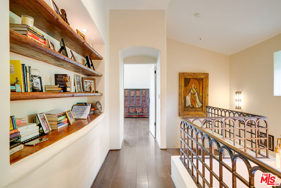 11670 Duque Drive Studio City, CA 91604 - Photo 21 of 48 a view of a hallway with wooden floor and furniture