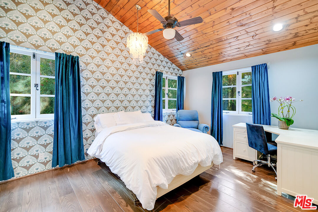 11670 Duque Drive Studio City, CA 91604 - Photo 29 of 48 a large bed sitting in a bedroom next to a window