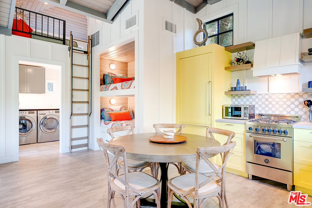 11670 Duque Drive Studio City, CA 91604 - Photo 37 of 48 a view of a dining room with furniture a chandelier and wooden floor