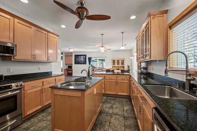 a kitchen with a stove a sink and a refrigerator
