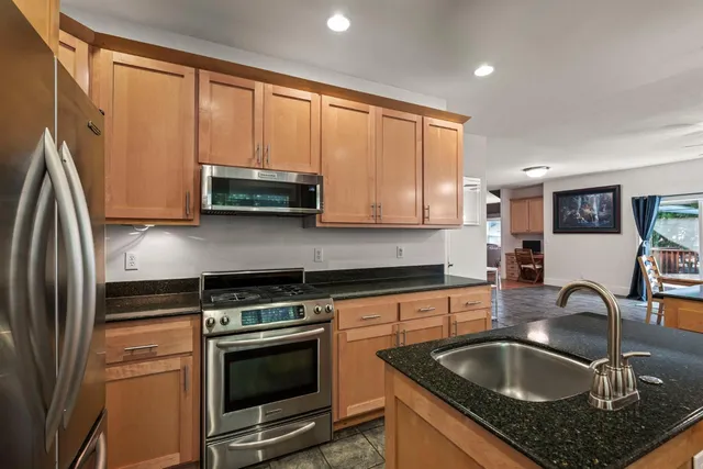 a dining room with furniture a floor to ceiling window and a fireplace