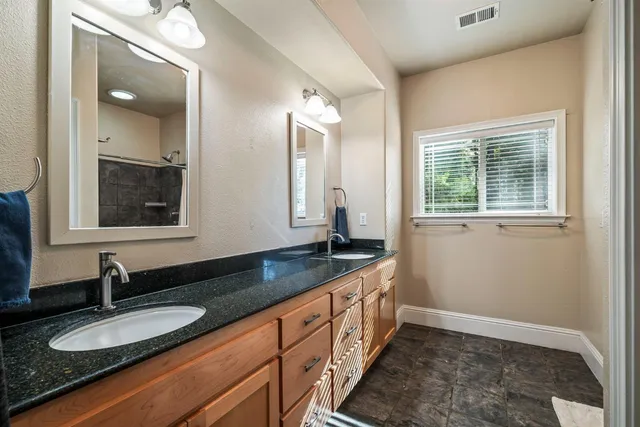 a bathroom with a sink a toilet and a mirror