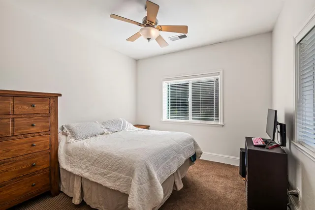 a utility room with a sink a vanity and a mirror