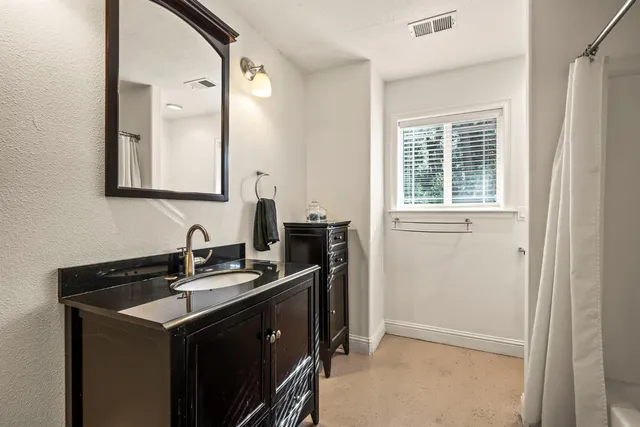 a bedroom with furniture and a window