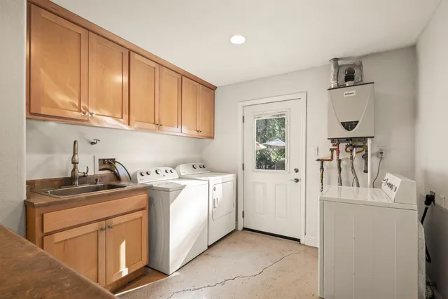 a view of a house with backyard and sitting area