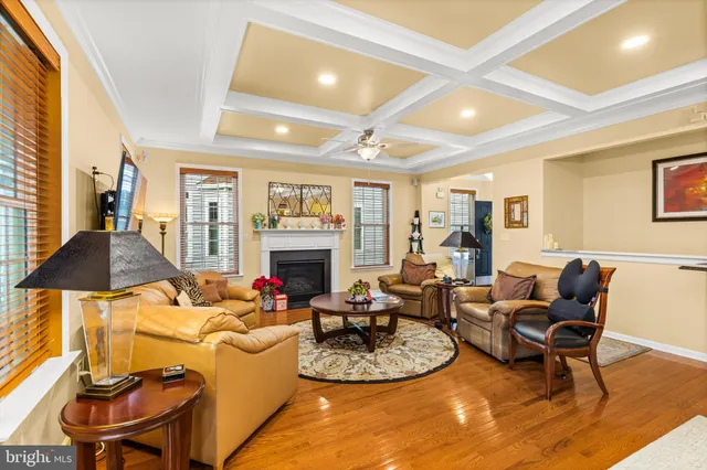 a living room with furniture a fireplace and a large window