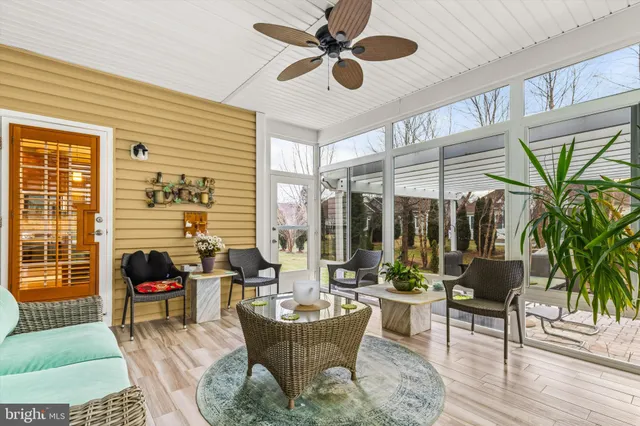 a living room with furniture and a floor to ceiling window