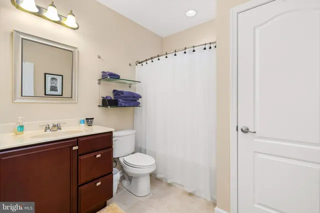 a white toilet sitting next to a bathroom sink