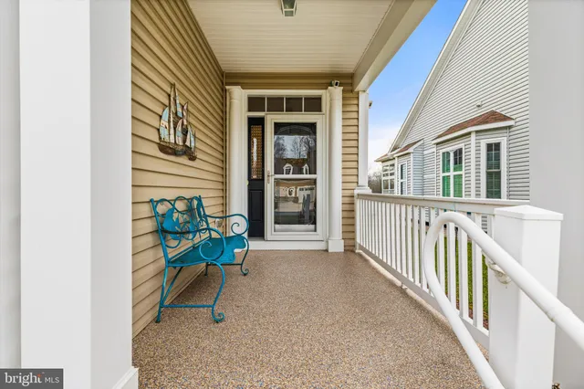 a view of a house with a wooden bench
