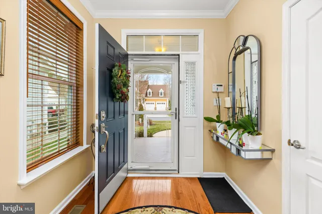 hallway with wooden floor and windows