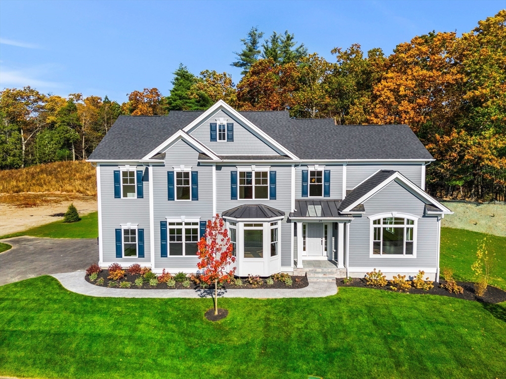 24 Rookery Lane, Unit 6 Concord, MA 01742 - Photo 1 of 41 a front view of a house with a yard potted plants and a large tree