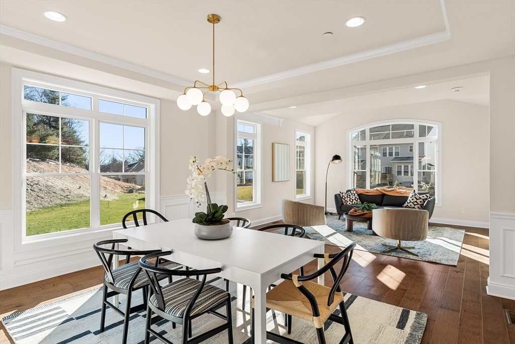 24 Rookery Lane, Unit 6 Concord, MA 01742 - Photo 11 of 41 a view of a dining room with furniture wooden floor and chandelier