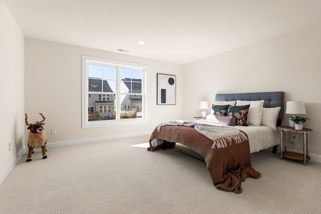 24 Rookery Lane, Unit 6 Concord, MA 01742 - Photo 19 of 41 a spacious bedroom with a bed and a window