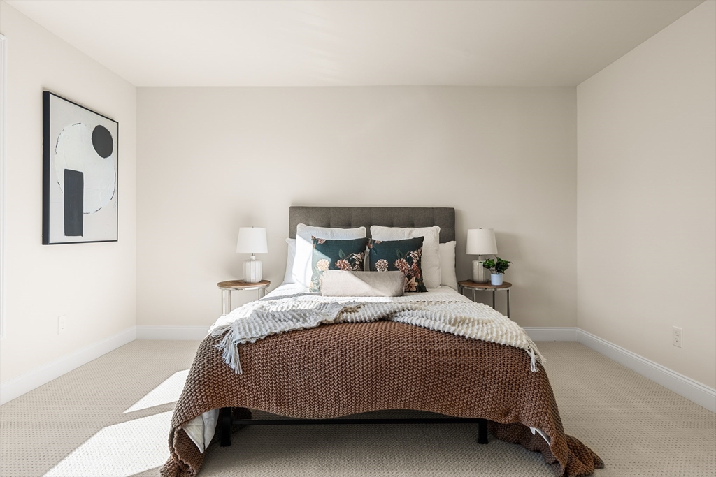 24 Rookery Lane, Unit 6 Concord, MA 01742 - Photo 20 of 41 a bedroom with a bed and painting on the wall