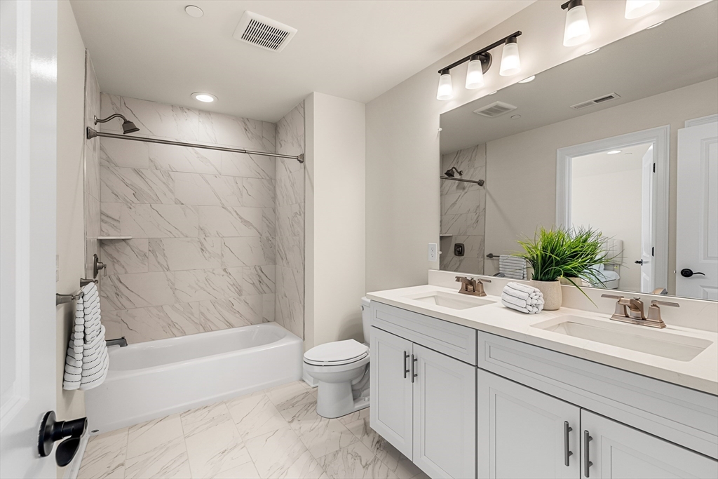 24 Rookery Lane, Unit 6 Concord, MA 01742 - Photo 22 of 41 a bathroom with a sink a toilet and a bathtub