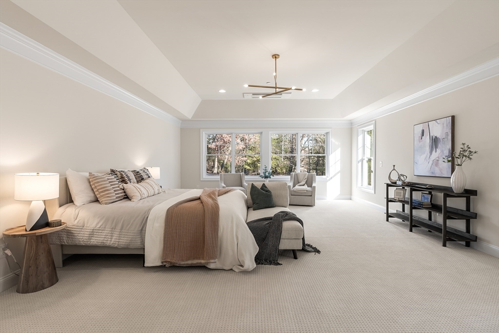24 Rookery Lane, Unit 6 Concord, MA 01742 - Photo 23 of 41 a spacious bedroom with a bed a couch and large window