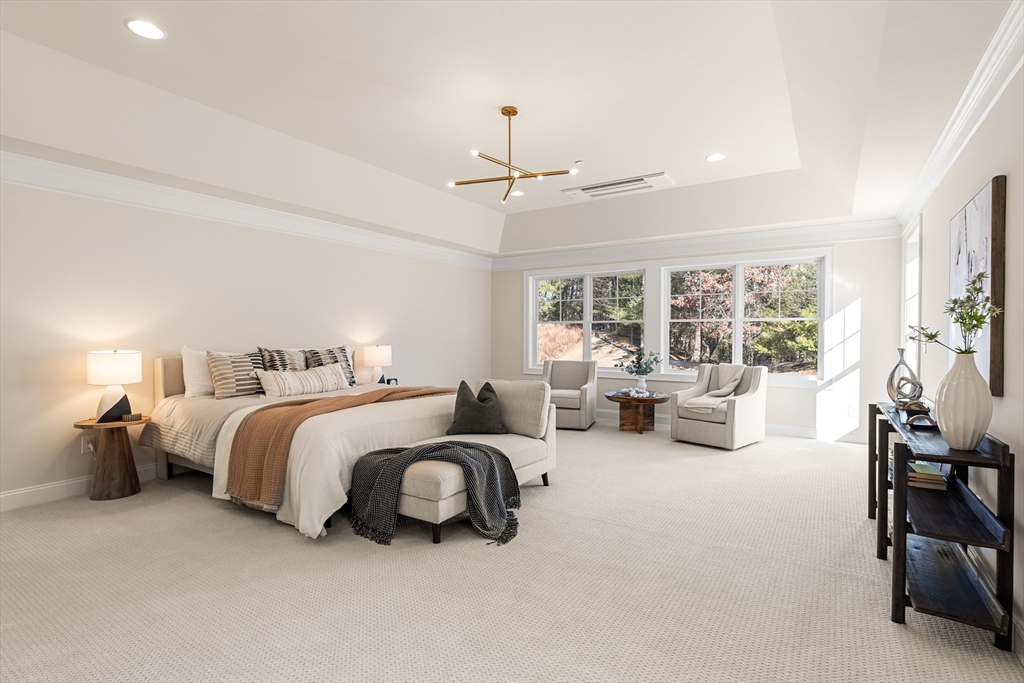 24 Rookery Lane, Unit 6 Concord, MA 01742 - Photo 24 of 41 a spacious bedroom with two beds and a chandelier