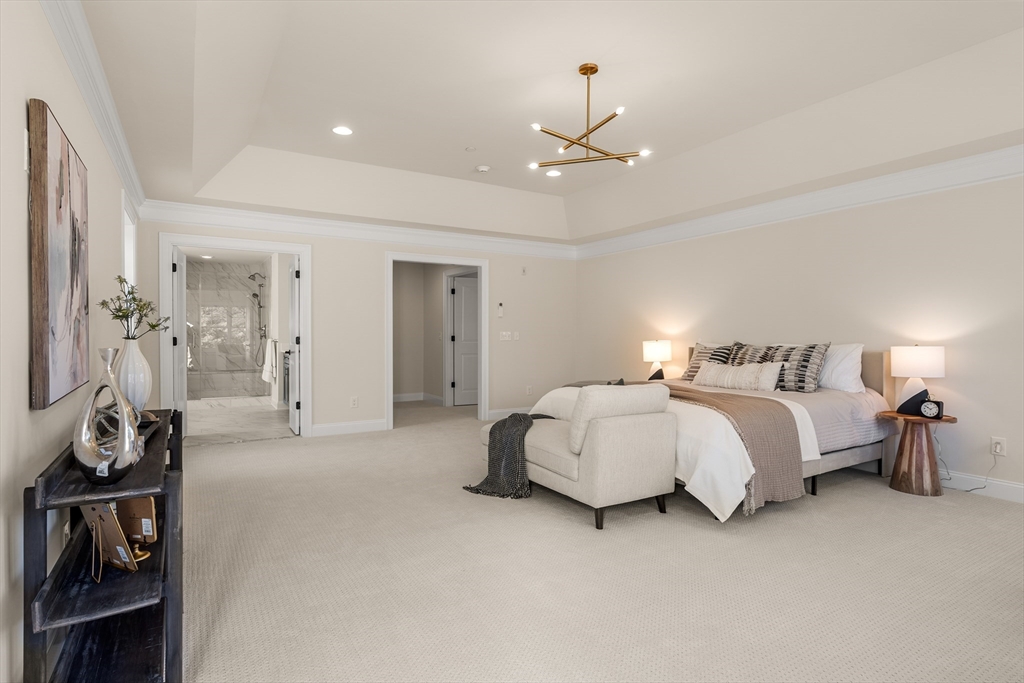 24 Rookery Lane, Unit 6 Concord, MA 01742 - Photo 25 of 41 a spacious bedroom with a bed and ceiling fan