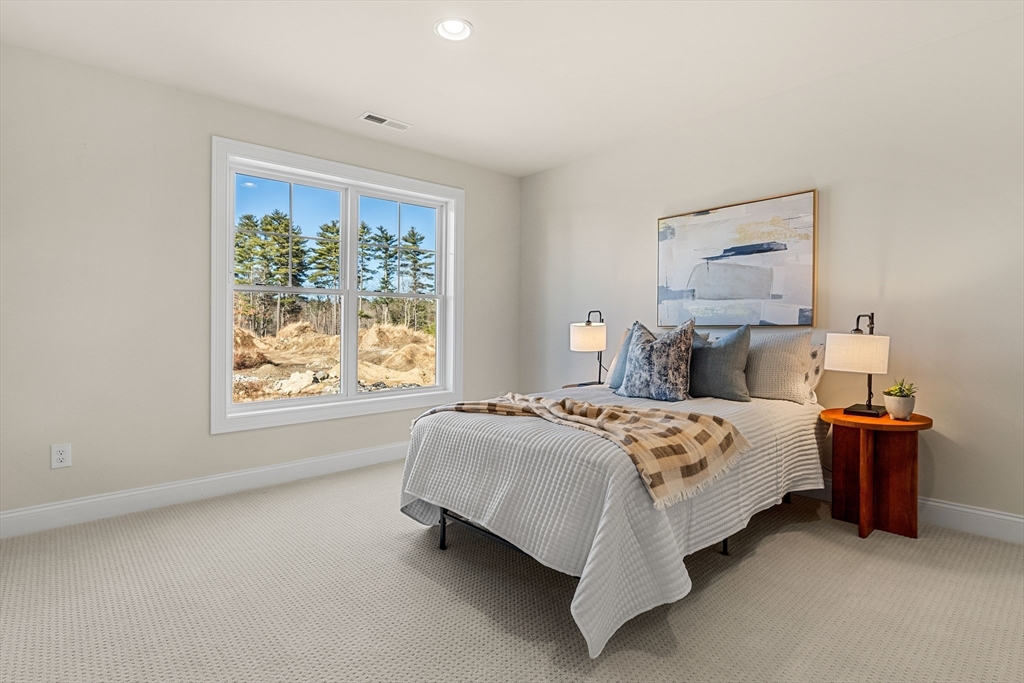 24 Rookery Lane, Unit 6 Concord, MA 01742 - Photo 28 of 41 a bed sitting in a bedroom next to a window