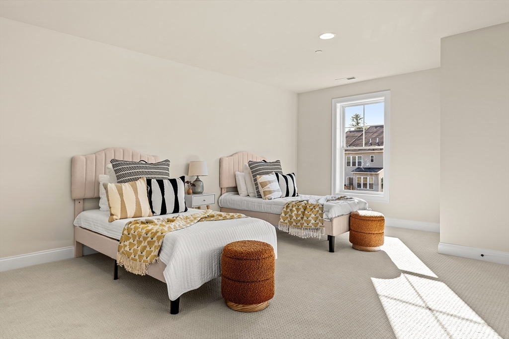 24 Rookery Lane, Unit 6 Concord, MA 01742 - Photo 31 of 41 a bedroom with a bed and a painting on the wall