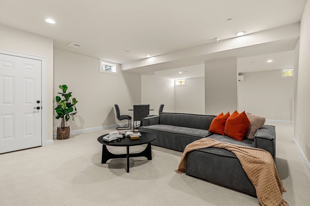 24 Rookery Lane, Unit 6 Concord, MA 01742 - Photo 35 of 41 a living room with furniture or couch and a potted plant