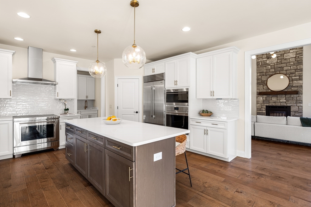 24 Rookery Lane, Unit 6 Concord, MA 01742 - Photo 7 of 41 a kitchen with white cabinets and stainless steel appliances