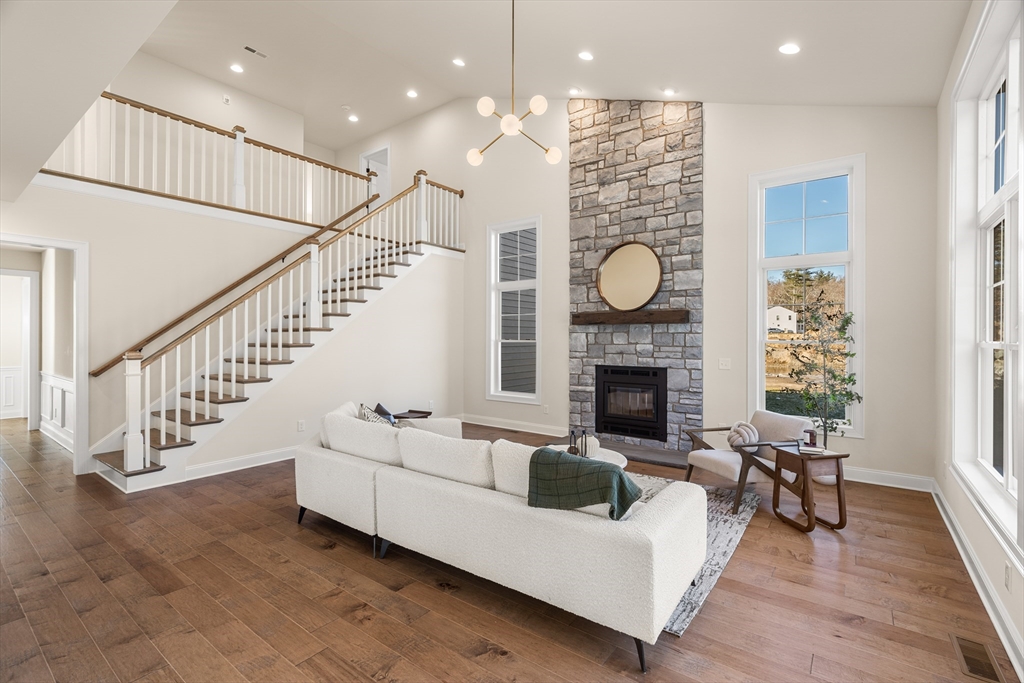 24 Rookery Lane, Unit 6 Concord, MA 01742 - Photo 10 of 41 a living room with fireplace furniture and a wooden floor