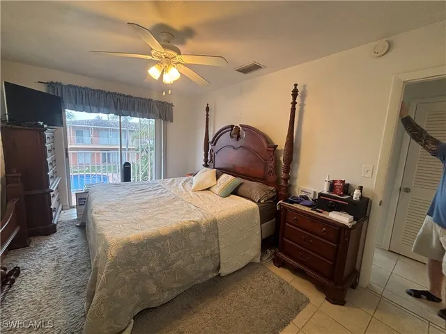 a bedroom with a bed and a television