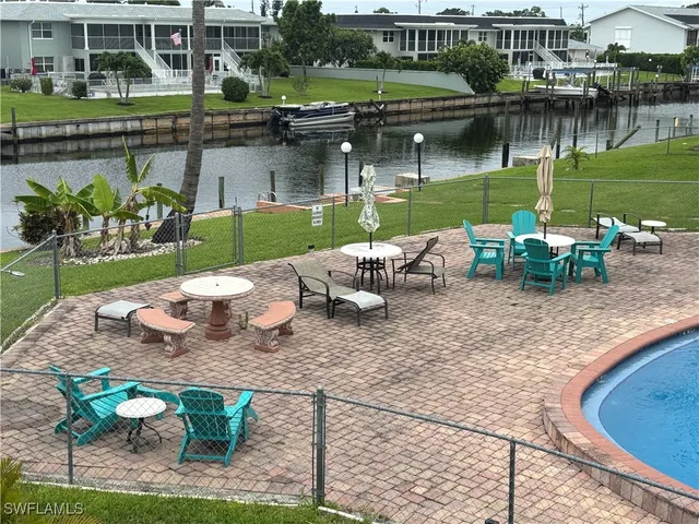 a view of a lake with a table and chairs