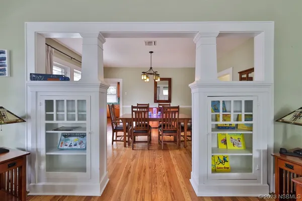 a kitchen with stainless steel appliances granite countertop wooden floor window and cabinets