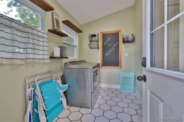 a bathroom with a toilet sink vanity and mirror