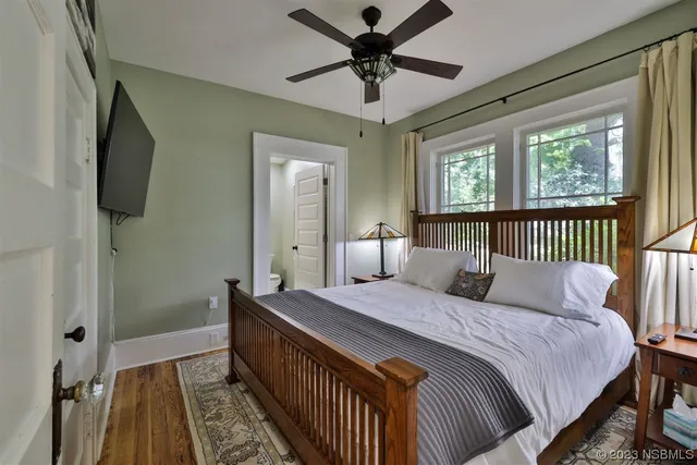 a bedroom with a bed window and a table