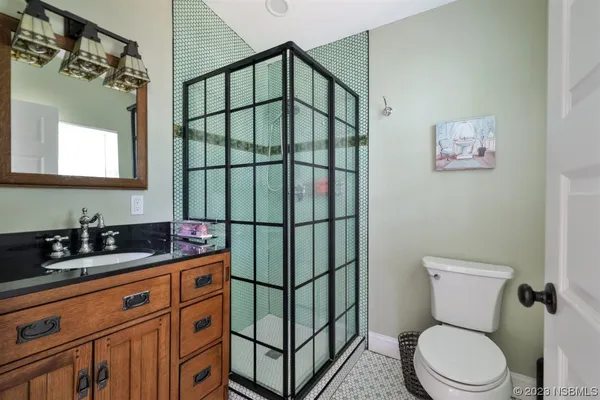 a bedroom with a bed and ceiling fan