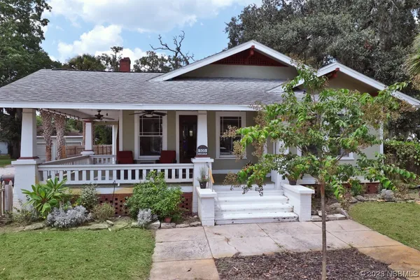 a front view of a house with a yard table and chairs