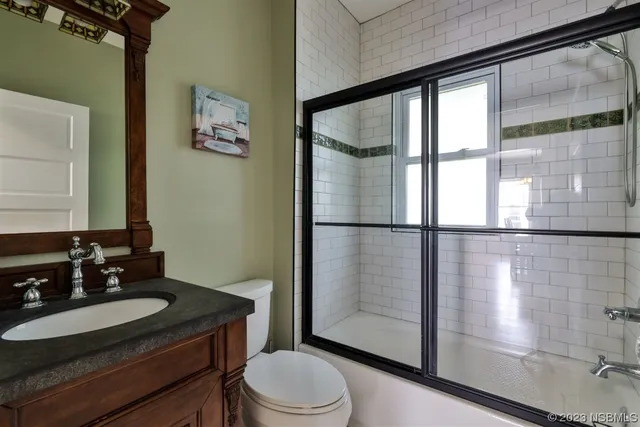 a view of house with a large tree and wooden fence